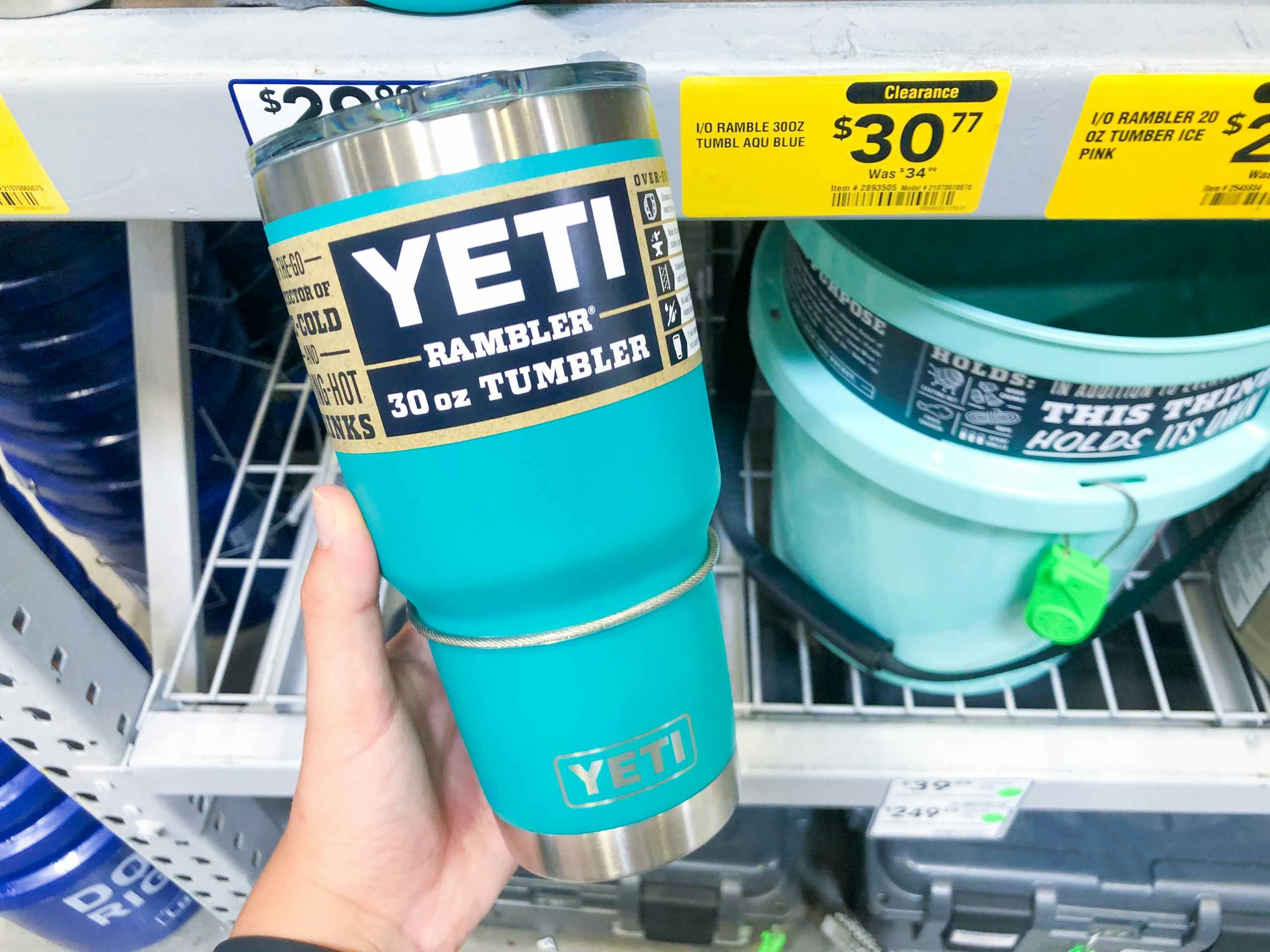 hand holding YETI mug in front of clearance display at Lowe's