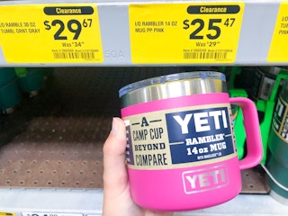 hand holding YETI mug in front of clearance display at Lowe's