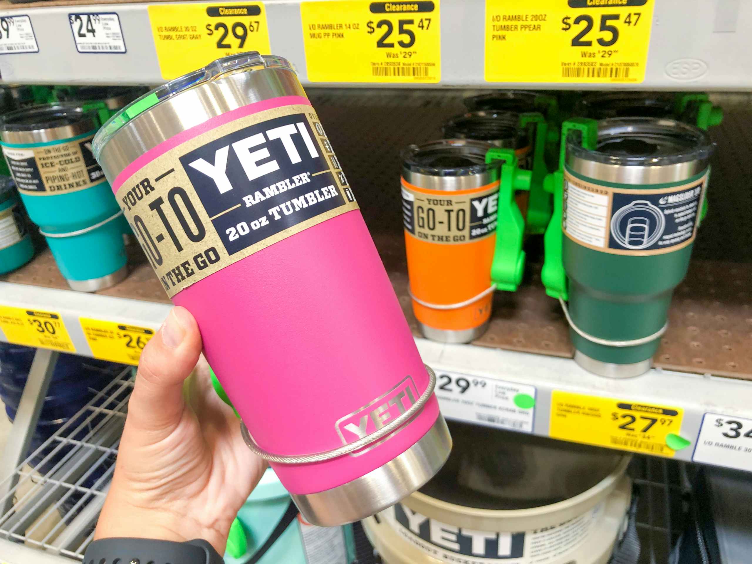 hand holding YETI mug in front of clearance display at Lowe's