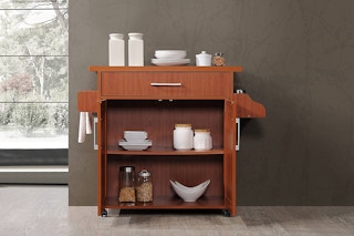 A kitchen island in a hallway of a home.