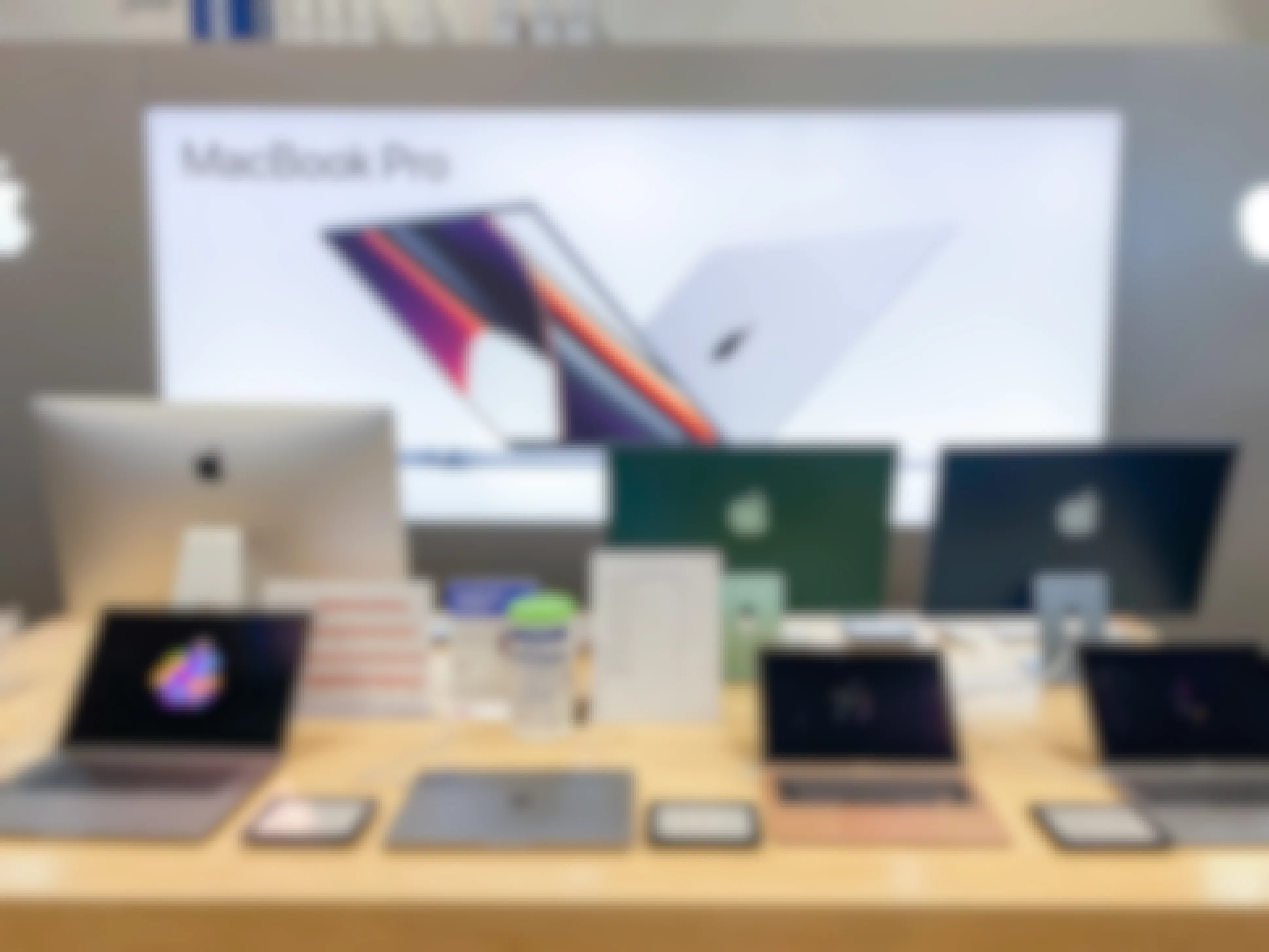macbook pro signage and laptops on display in store 