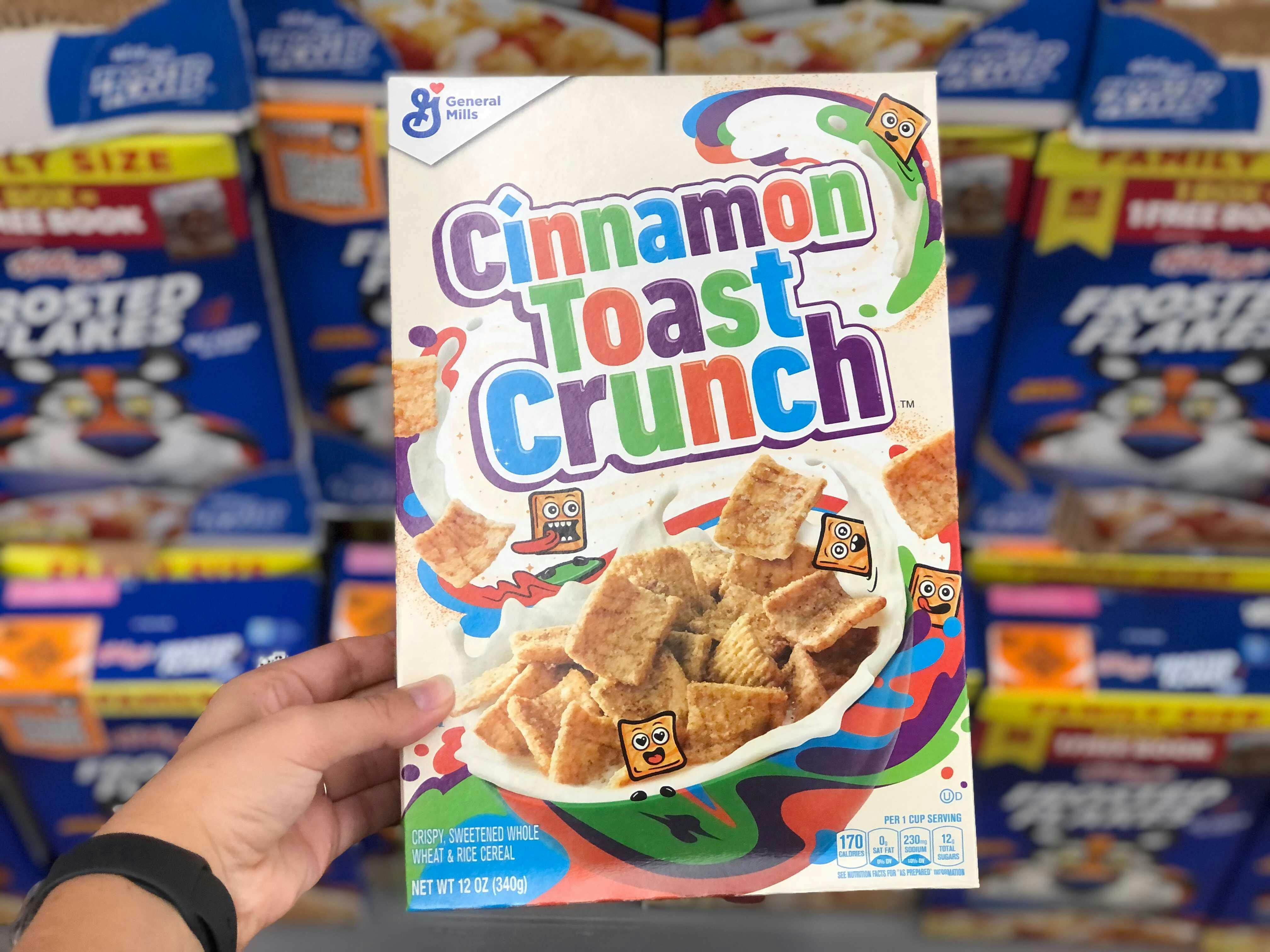 Someone holding up a box of Cinnamon Toast Crunch cereal