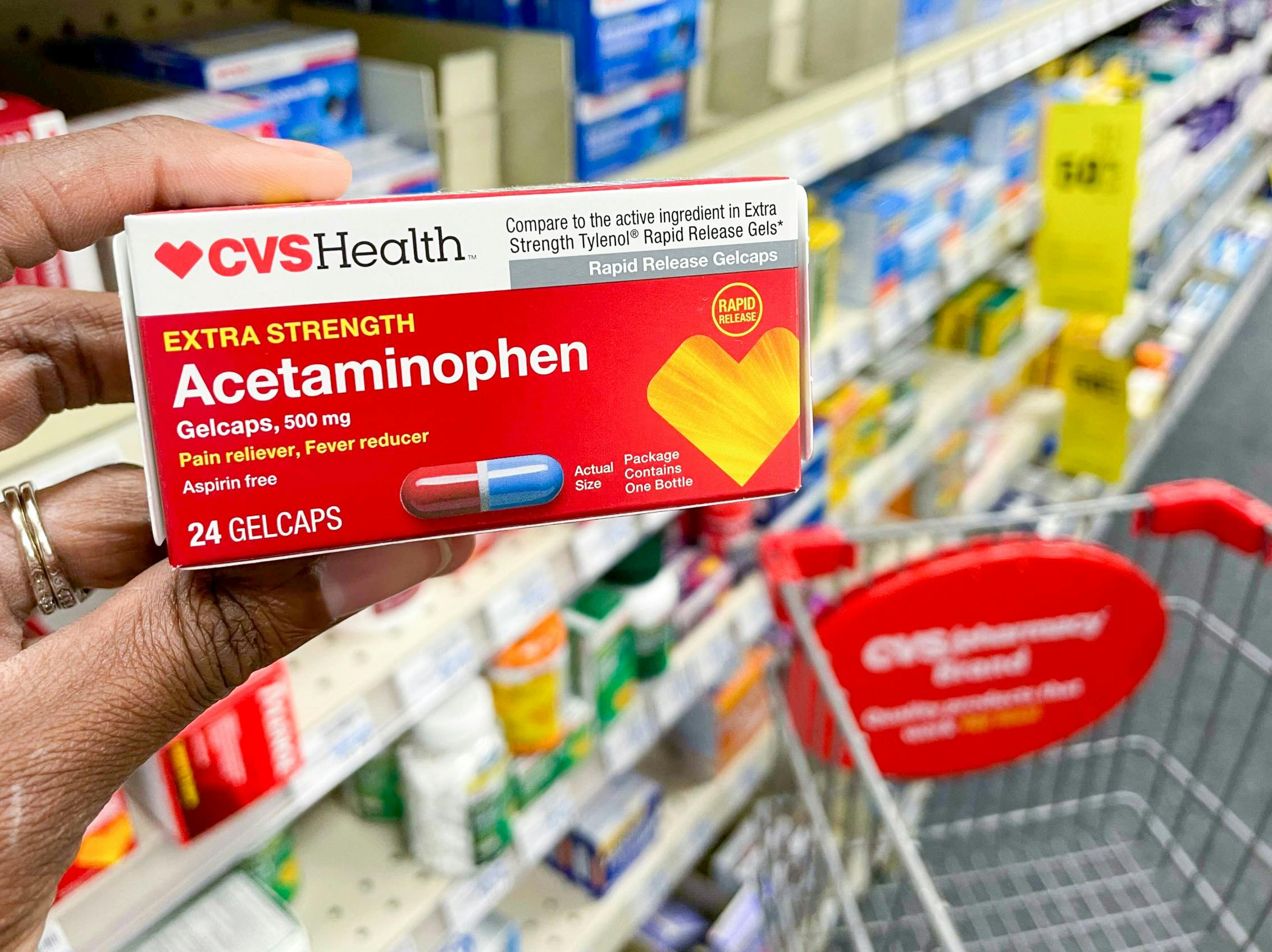 Someone holding a package of generic CVS brand acetaminophen