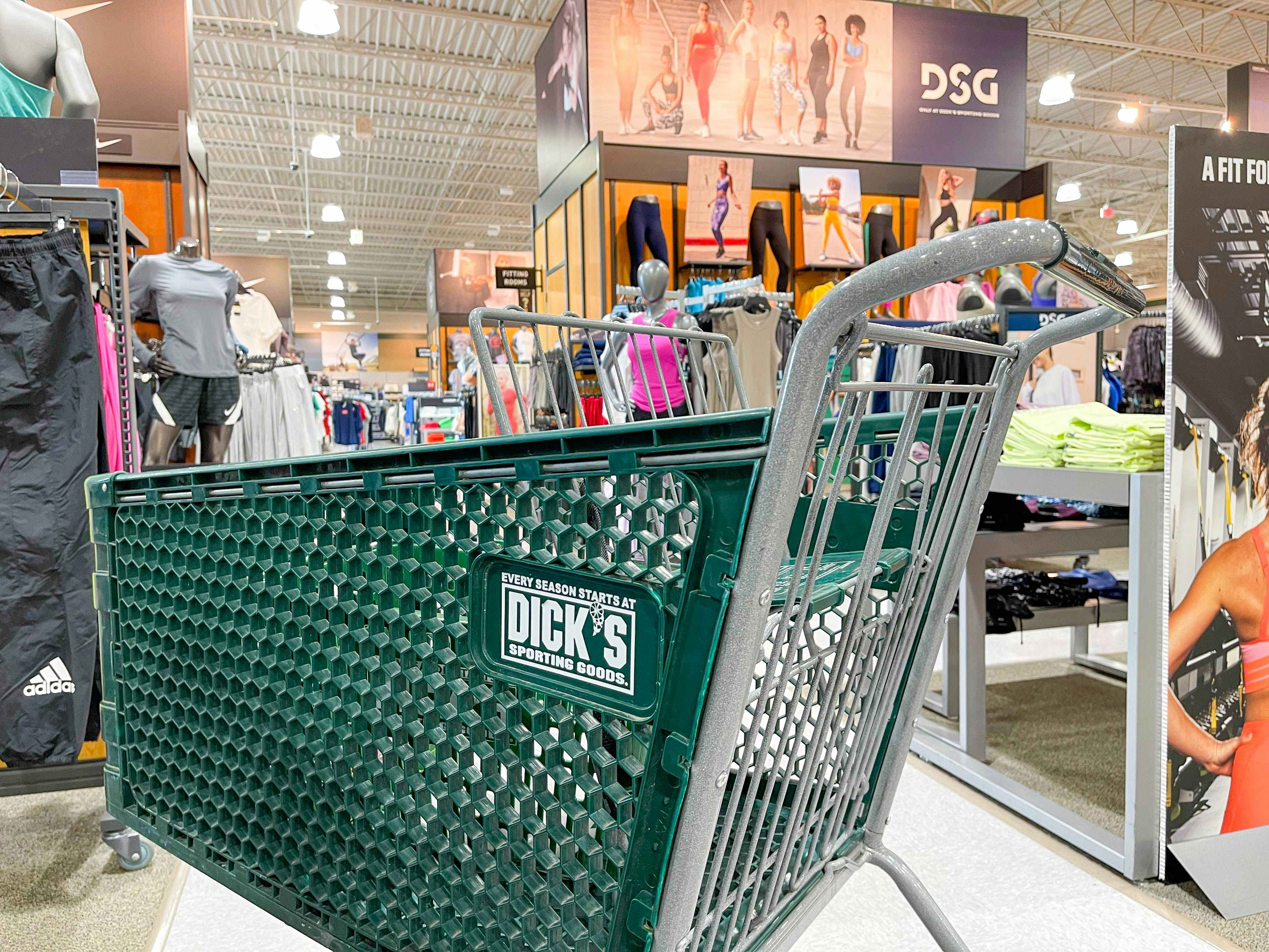 A Dick's Sporting Goods shopping cart in the middle of an aisle at Dick's.