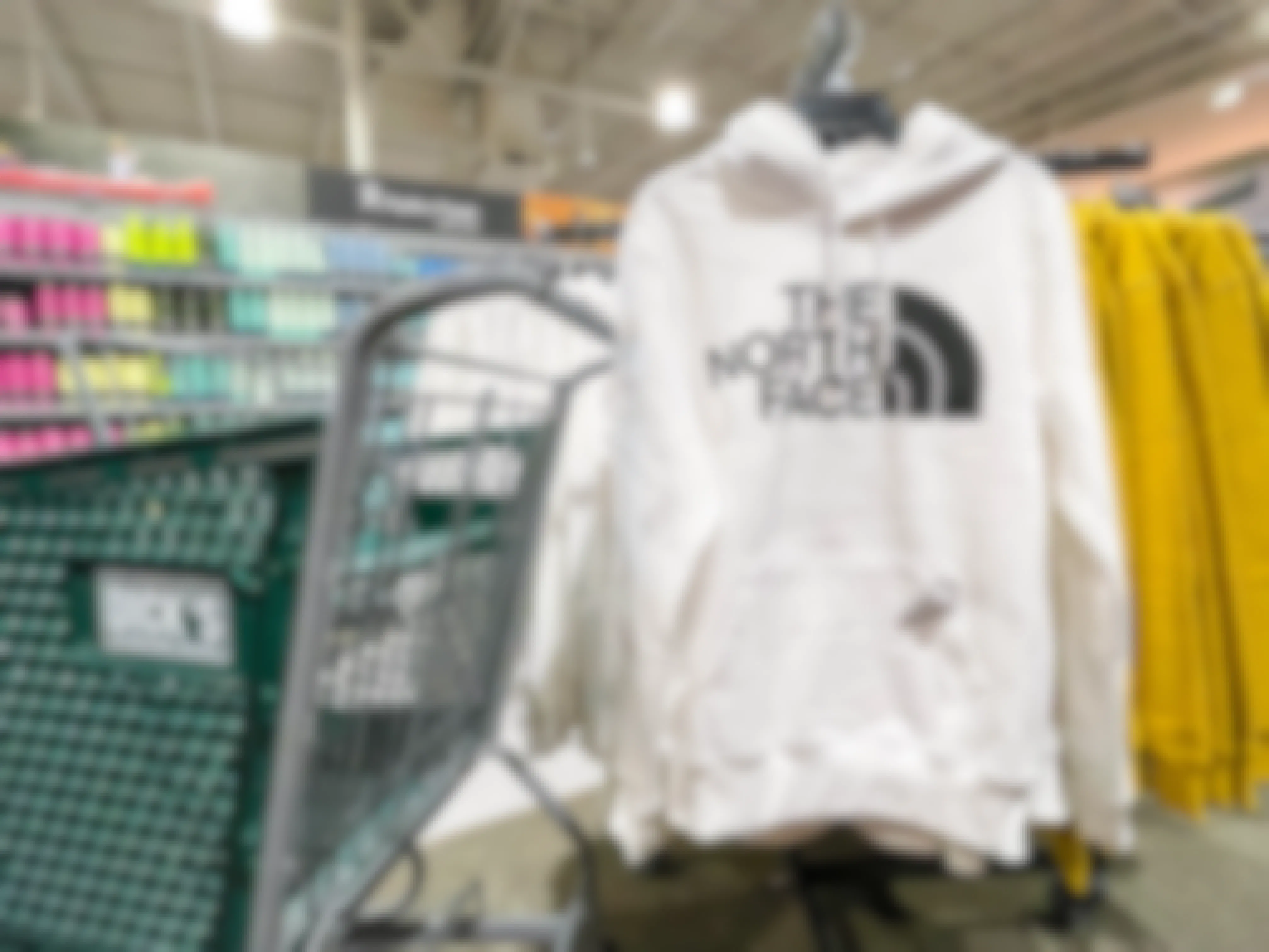 A The North face sweater next to a Dicks sporting Goods shopping cart