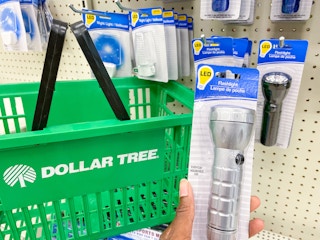 a flashlight held in hand next to a dollar tree basket in dollar tree