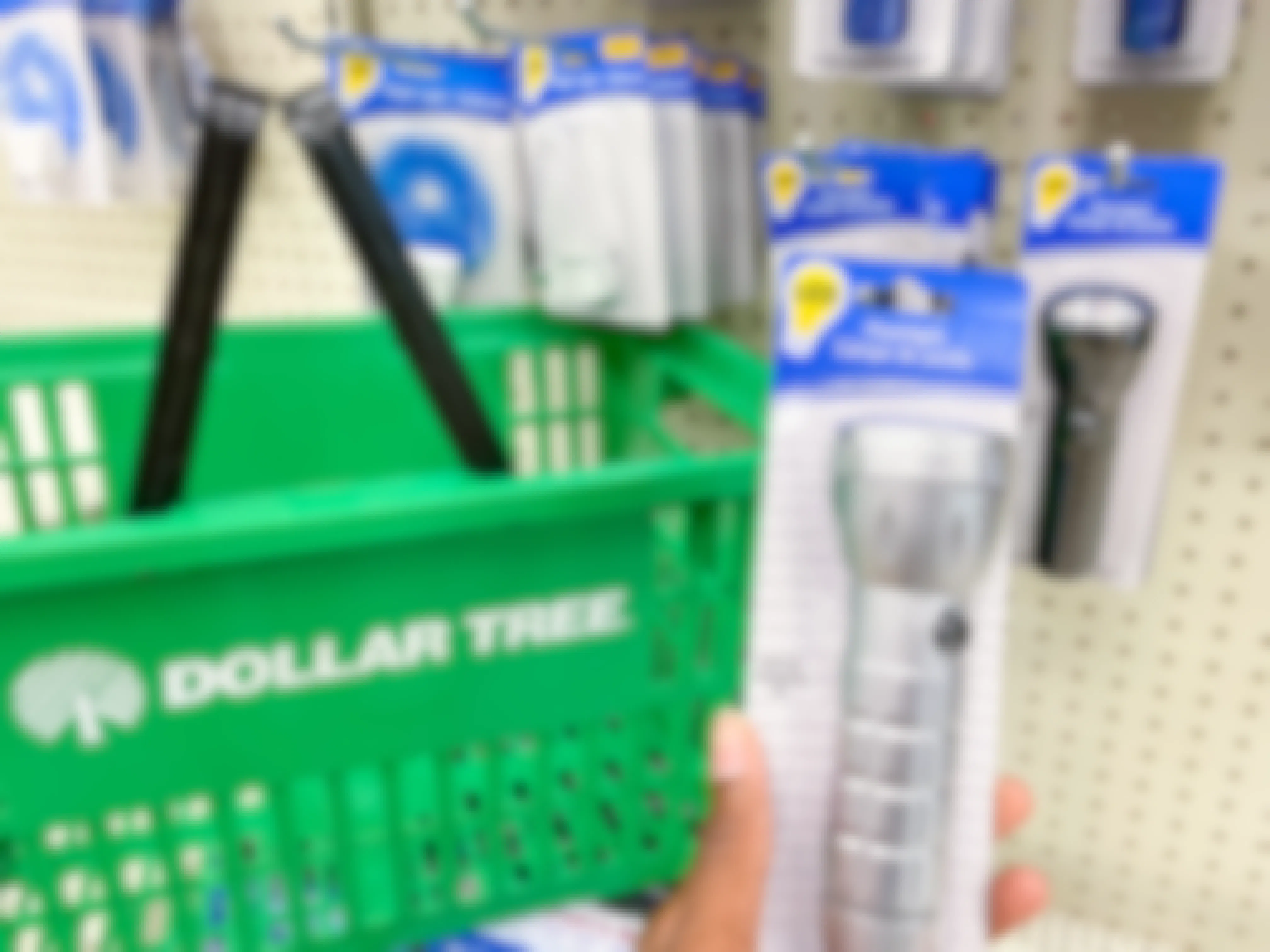a flashlight held in hand next to a dollar tree basket in dollar tree