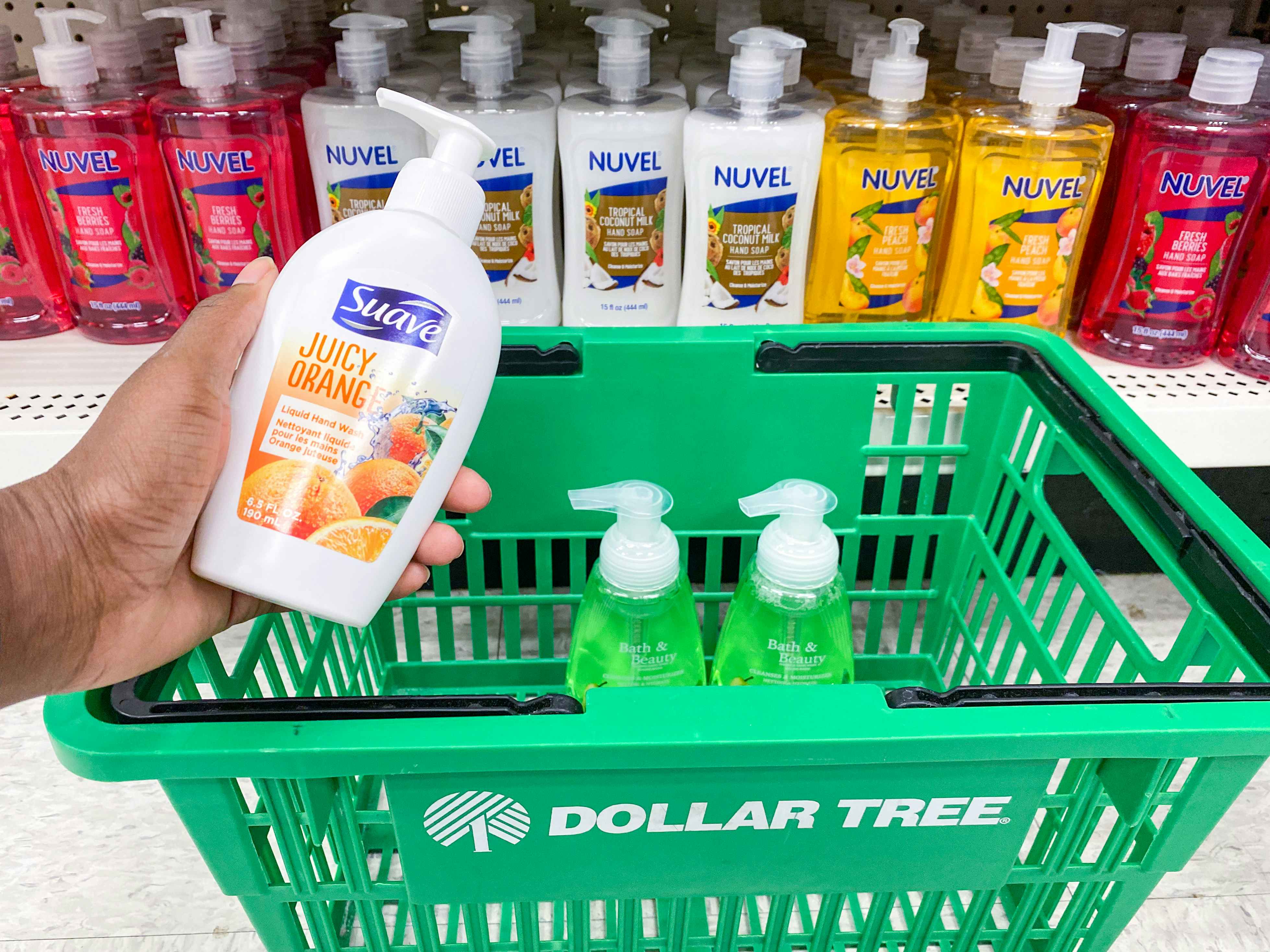 a bottle of hand soap being placed in a dollar tree basket with other hand soaps in the hand soap section in dollar tree 