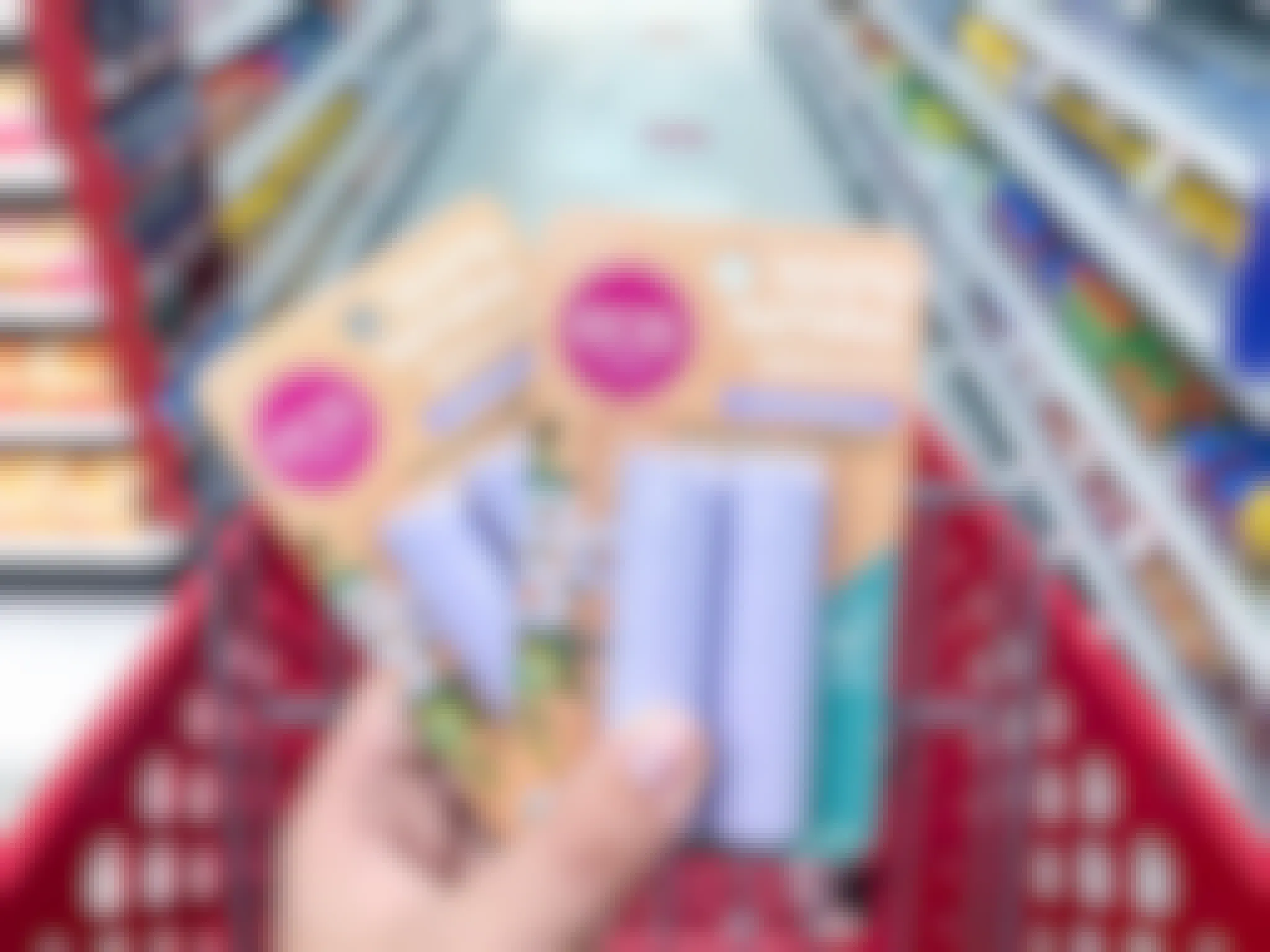 hand holding 2 packs of eos lip balm at target