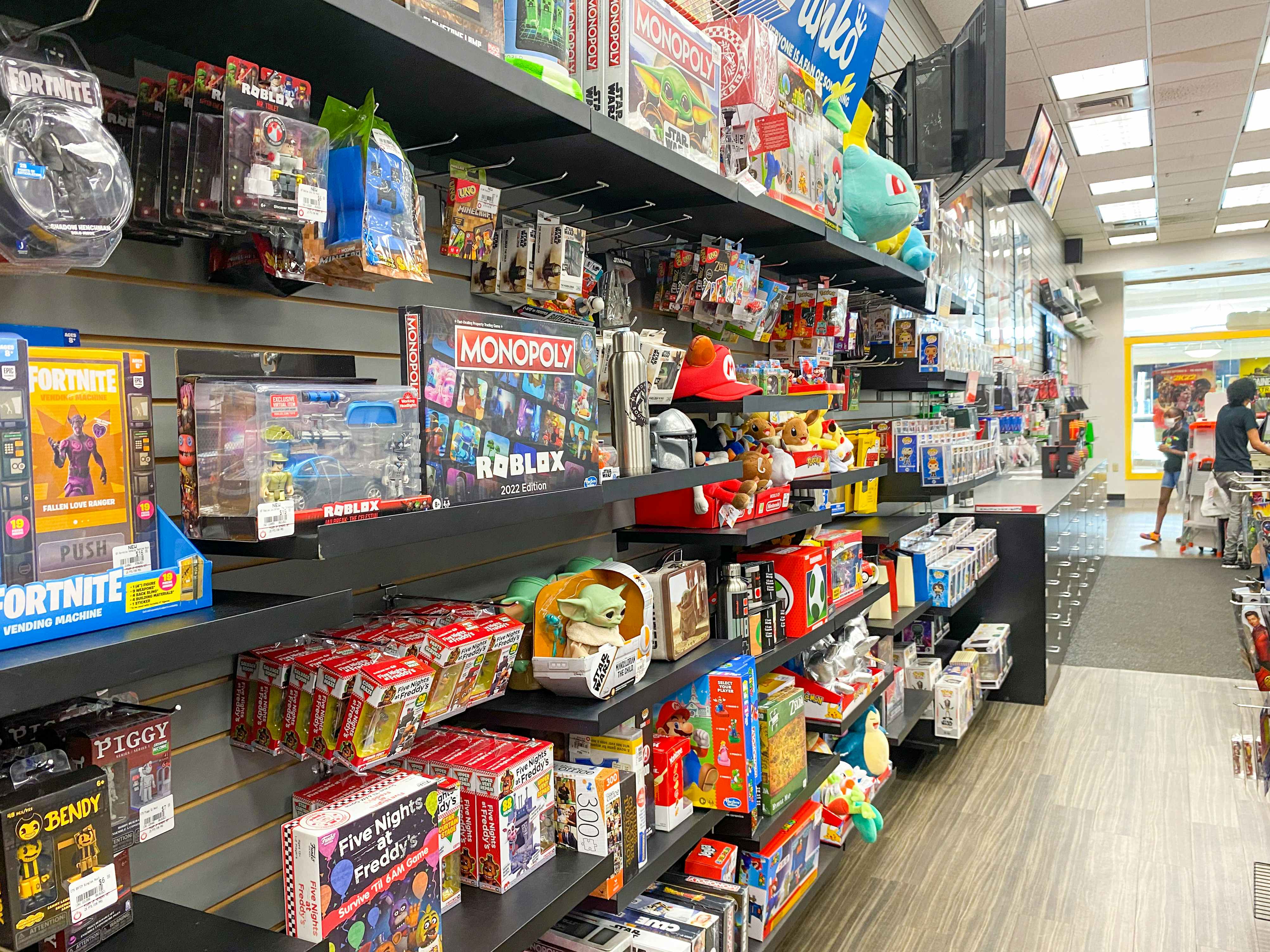 A wall of video game merchandise near the checkout counter inside GameStop.