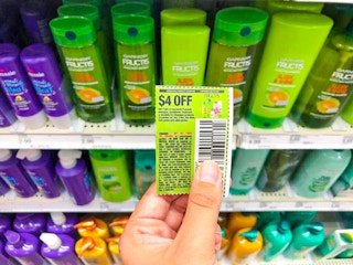 hand holding a garnier coupon at target