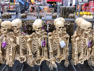 hanging posable skeletons on display at home depot