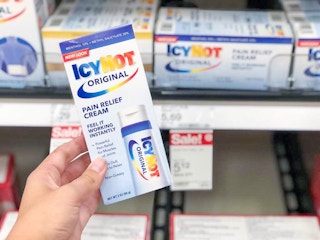 hand holding icy hot pain relief cream at target