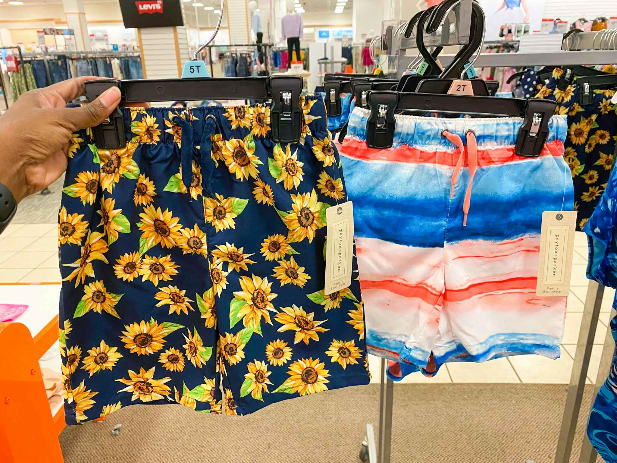 hand holding boys' swim trunks