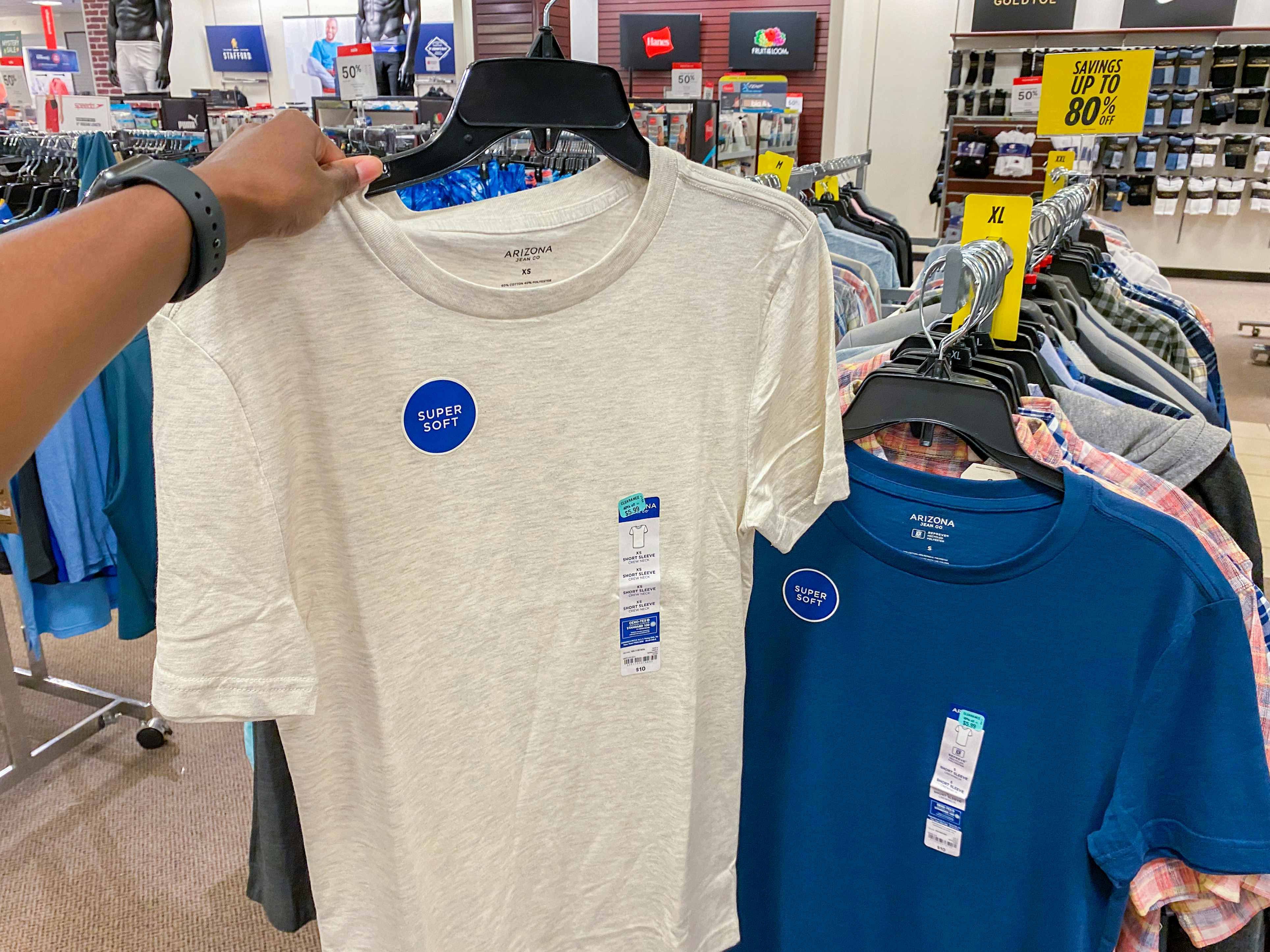 a t shirt being held beside another t shirt in the clearance section at jc penny