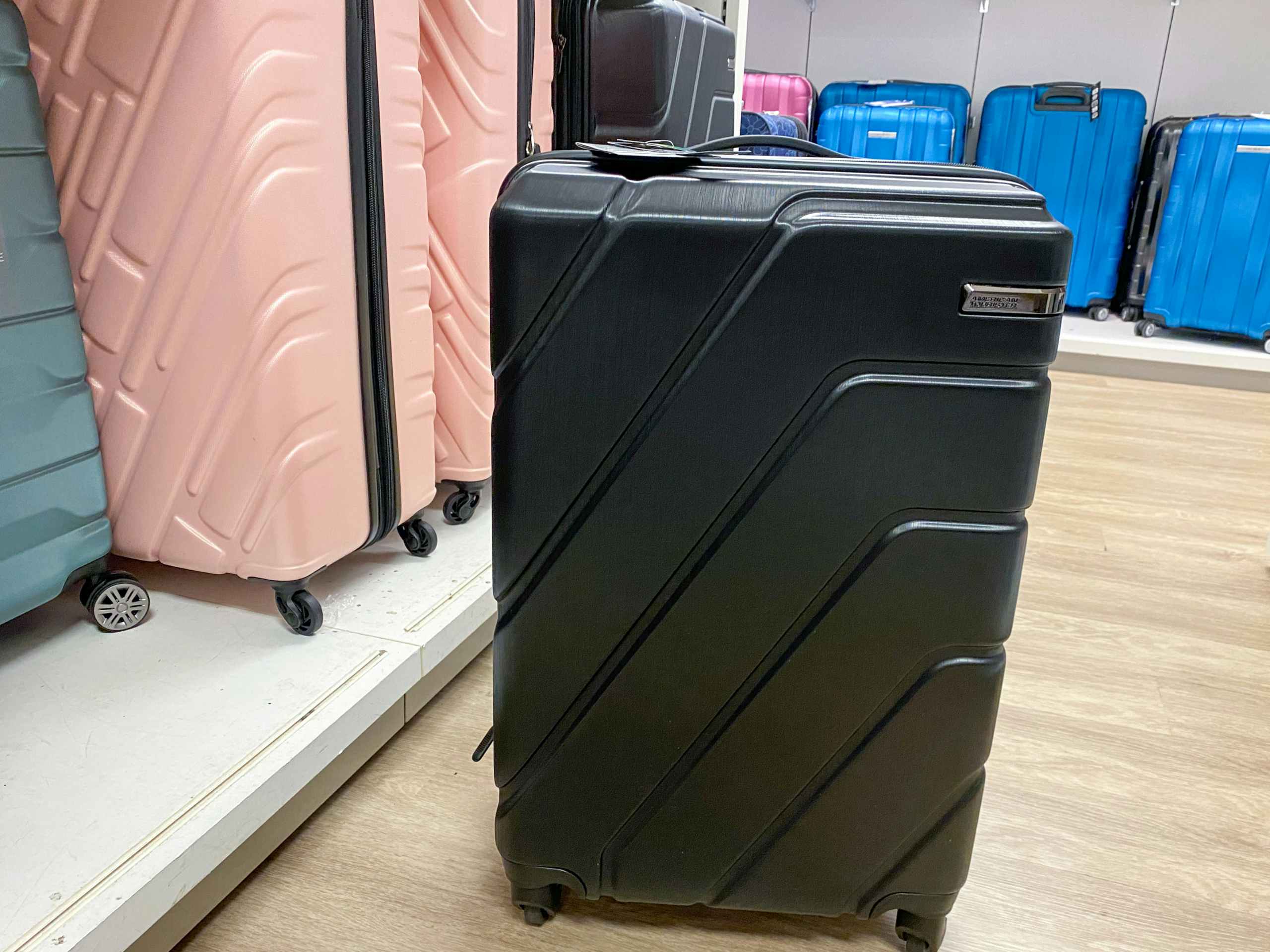 luggage on the floor next to a shelf of other luggages