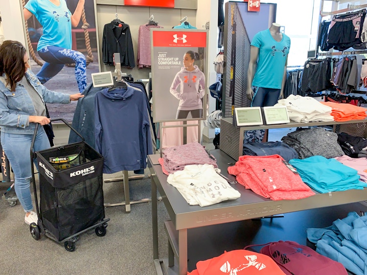 A woman shopping in the Under Armour section inside Kohls
