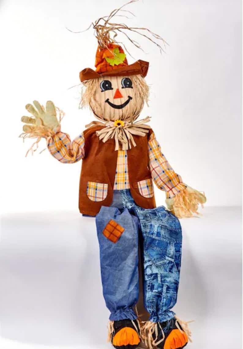stock photo of best selling scarecrow sitting on white platform