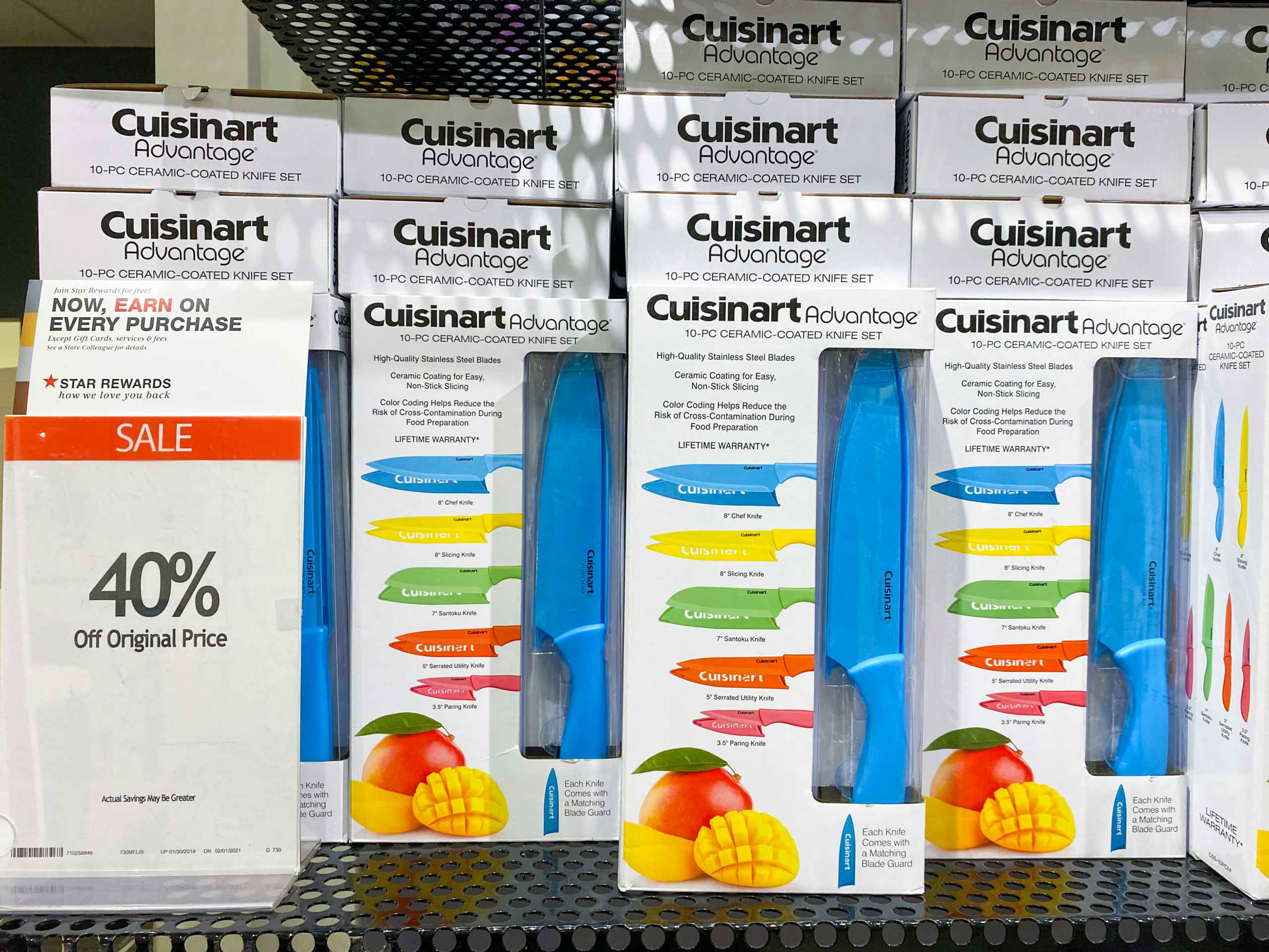 cuisinart knife sets lined up on a shelf with a sale sign reading 40 percent off next to it in macys