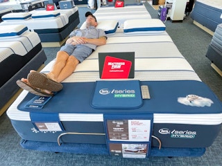 Mattress Firm display with man lying down and testing