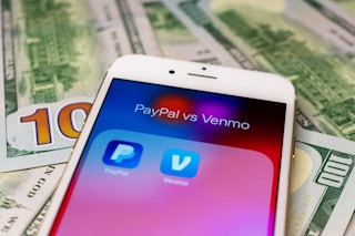 phone on top of money with a screen showing the venmo and paypal app