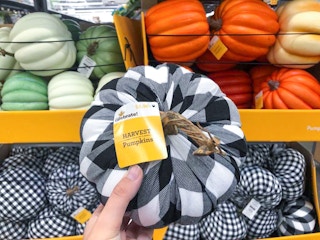 hand holding a plaid pumpkin at walmart