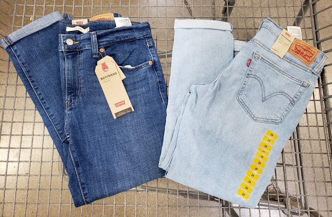 Two pairs of Levi's jeans in a cart.