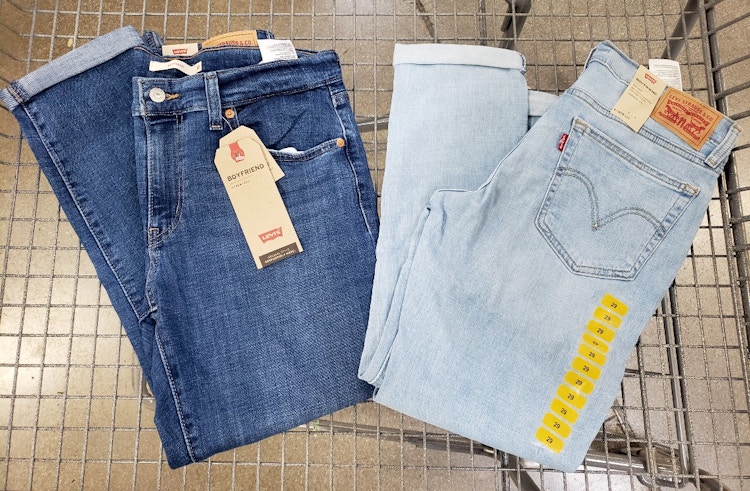 Two pairs of Levi's jeans in a cart.
