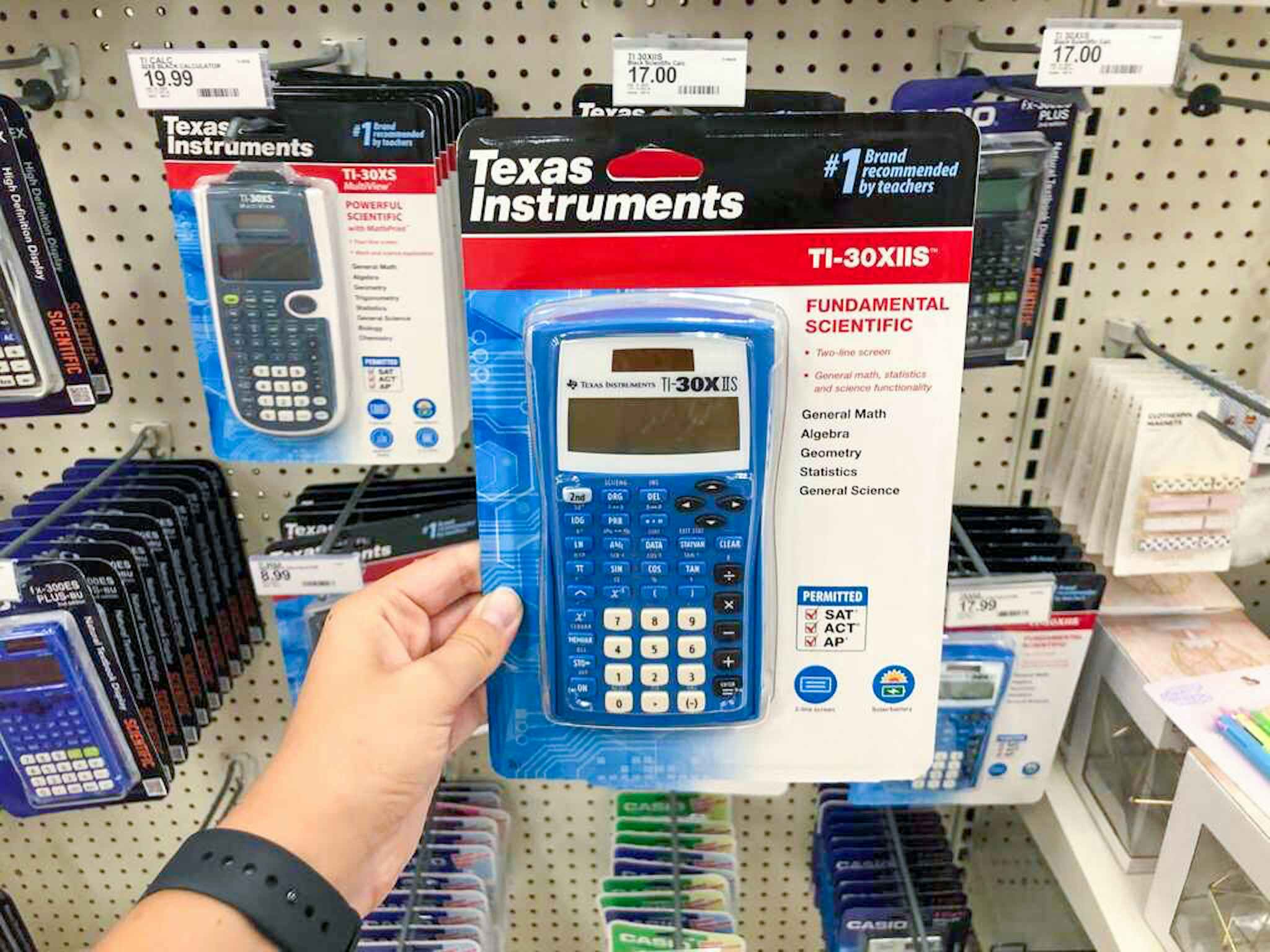 hand holding a texas instruments scientific calculator at target