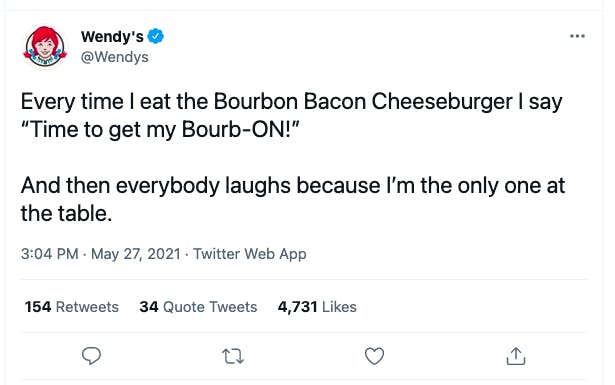 A screenshot of a tweet from the verified Wendy's Twitter account that reads, "Every time I eat the Bourbon Bacon Cheeseburger I say 'Time to get my Bourb-ON!' And then everybody laughs because I'm the only one at the table.