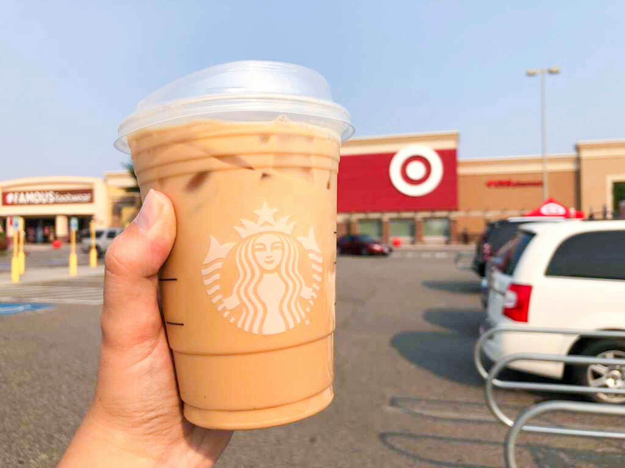 hand holding a starbucks iced beverage outside of target