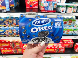 dannon yocrunch yogurt snacks held up in front of yogurt section of target