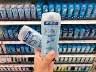 two sticks of secret aluminum free deodorant held up in front of more secret prodcuts