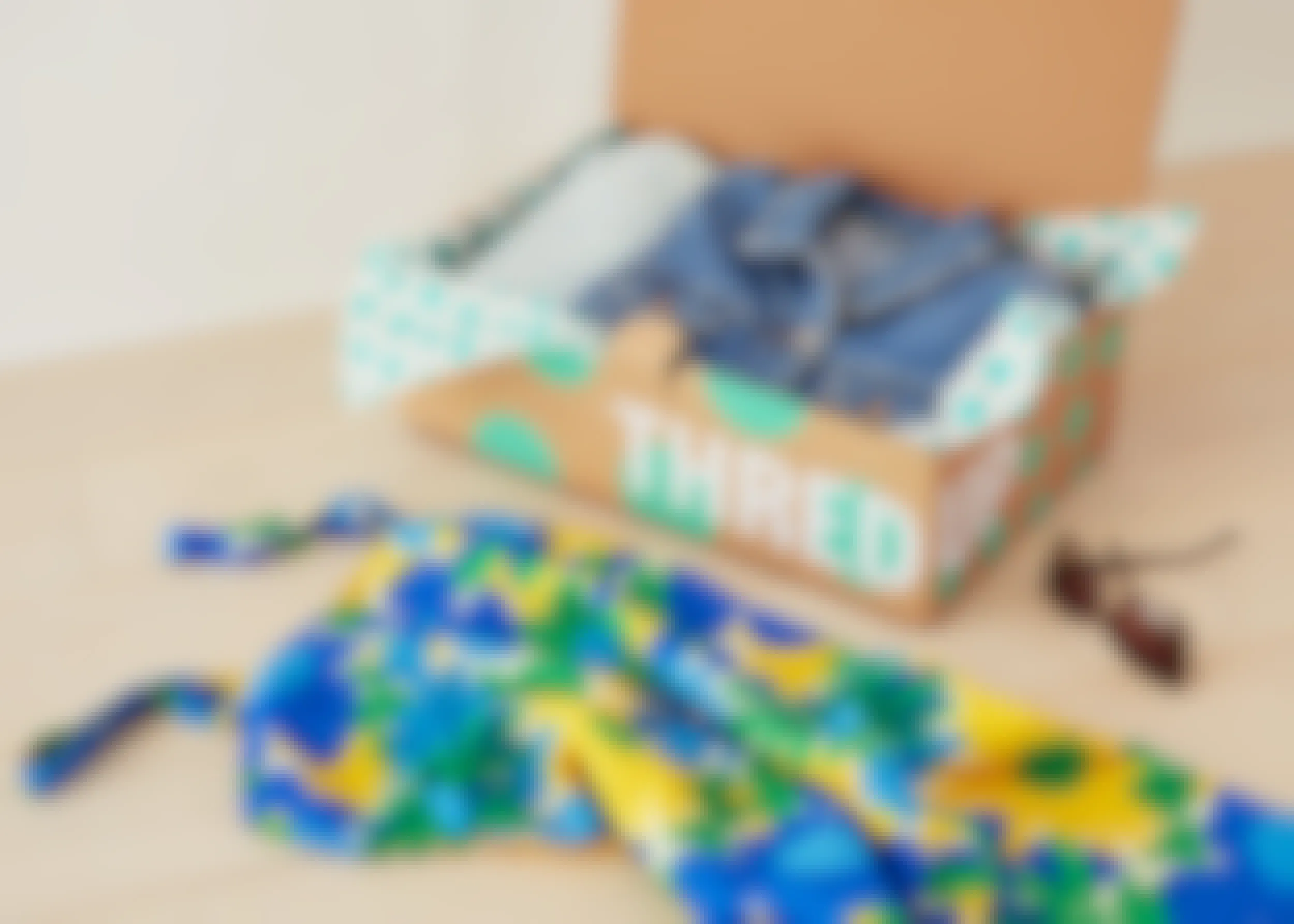 thredup box with jean jacket in it and with dress next to it