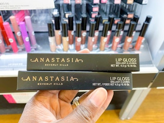 hand holding Anastasia Beverly Hills lip gloss
