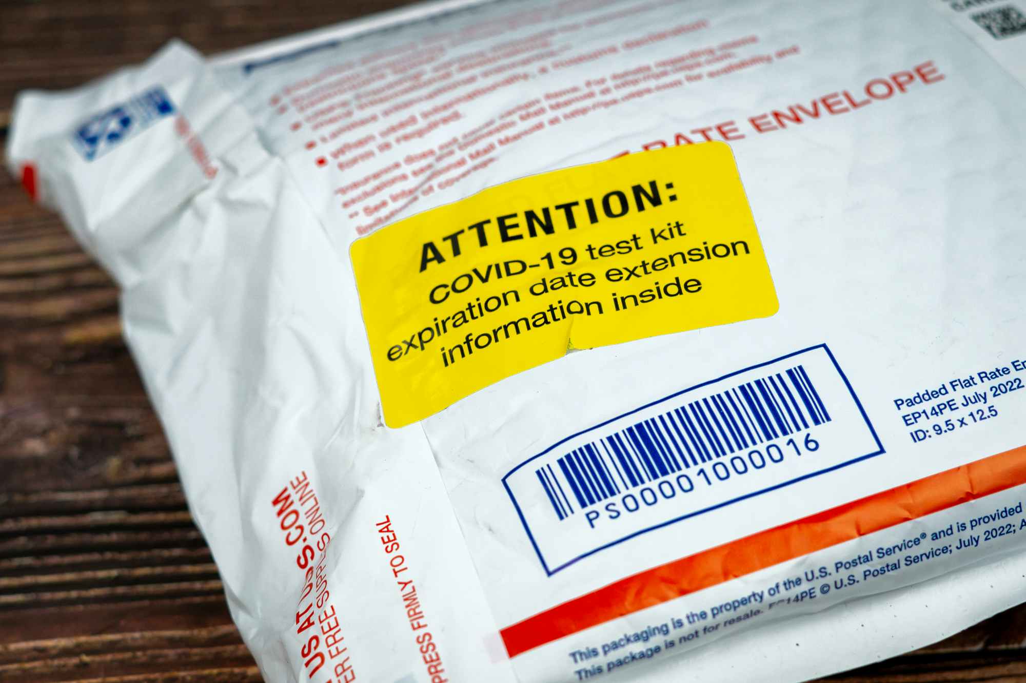 a close up on a sticker that says "Attention: COVID-19 test kit expiration date extension information inside