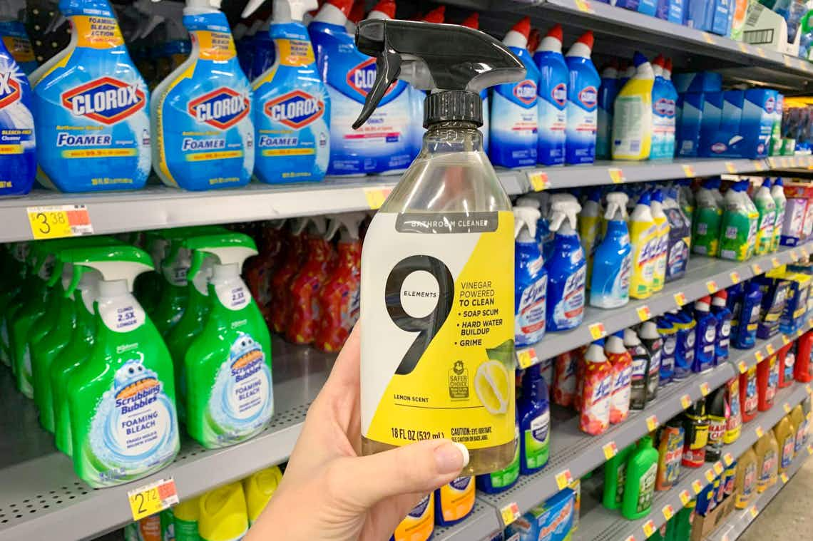 9 elements bathroom cleaner held in front of walmart shelves