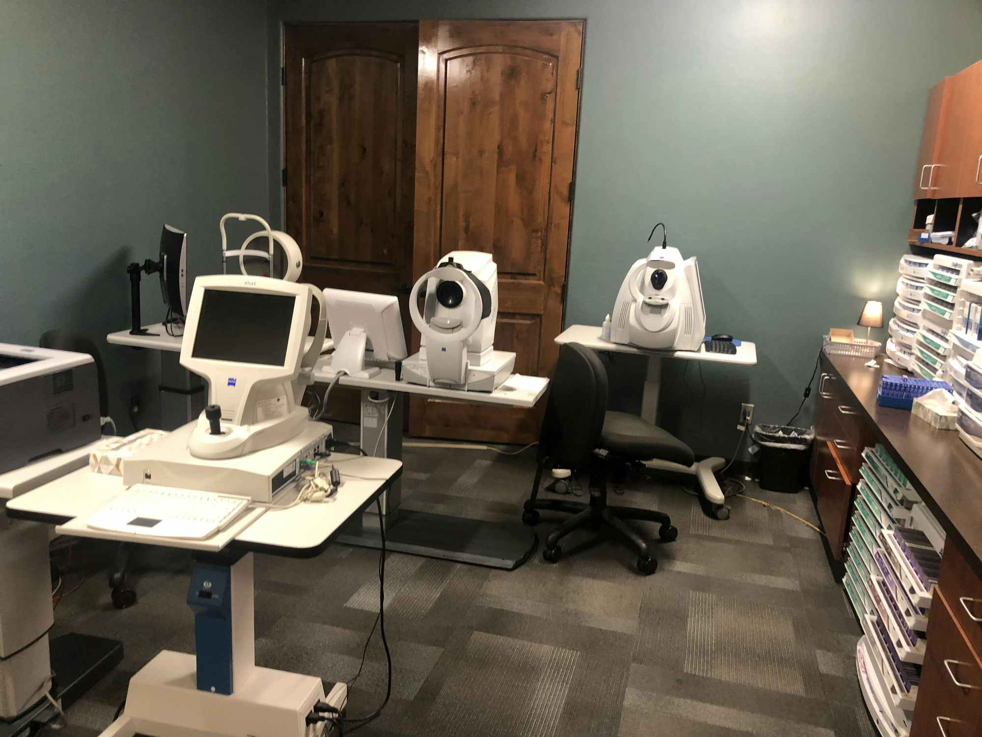 Eye doctors office with all of the complicated machinery and computers