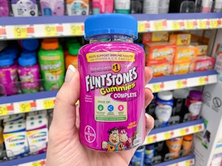 flintstones multivitamin gummies held up in front of other multivitamins