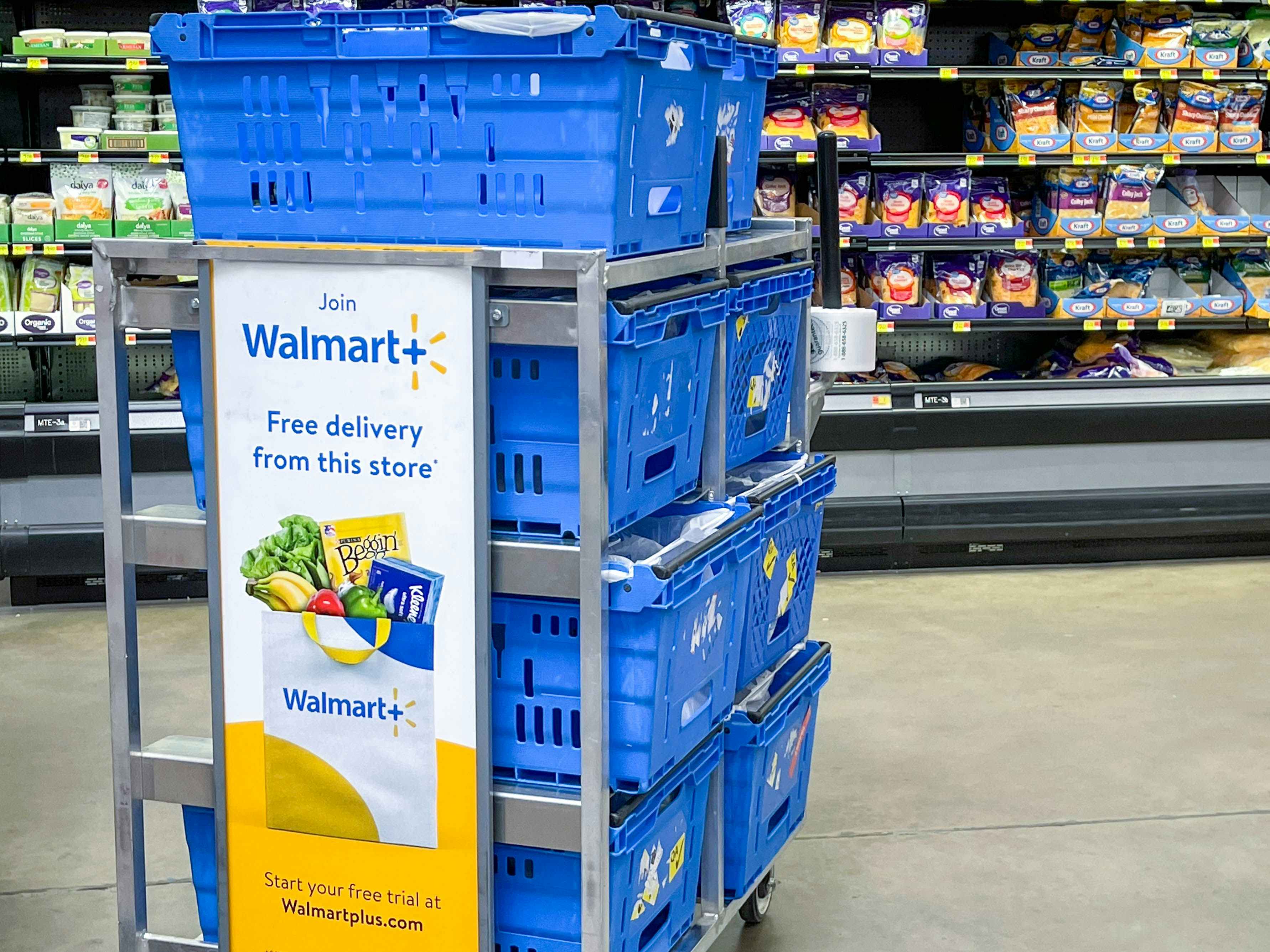 walmart plus sign in store on employee basket advertising free delivery and free trial of Walmart plus