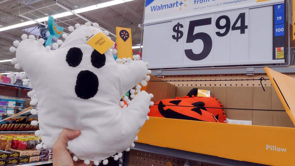 way to celebrate harvest ghost pillow held in front of price sign