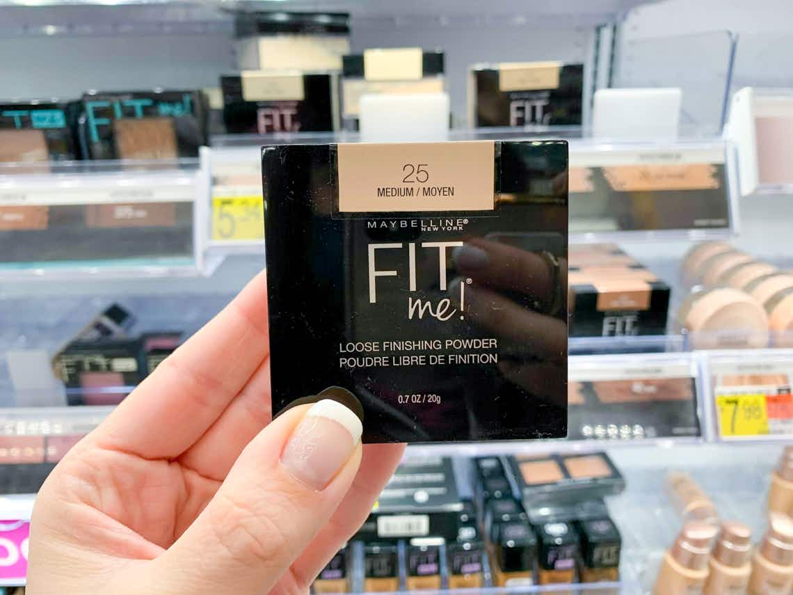 single maybelline fit me loose powder held up by hand