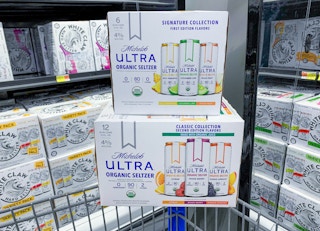 two boxes of michelob ultra seltzers stacked on walmart cart