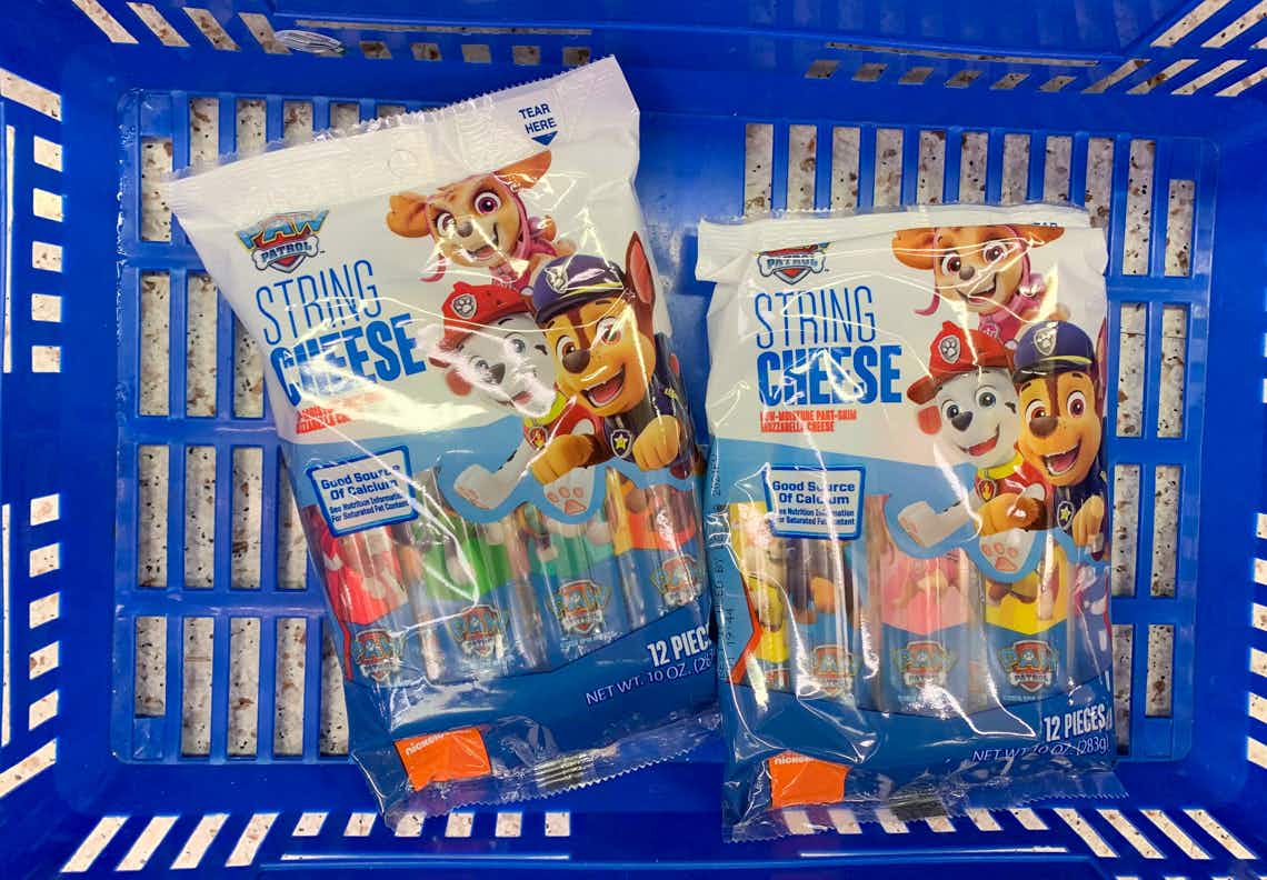 two bags of paw patrol string cheese in a walmart hand basket