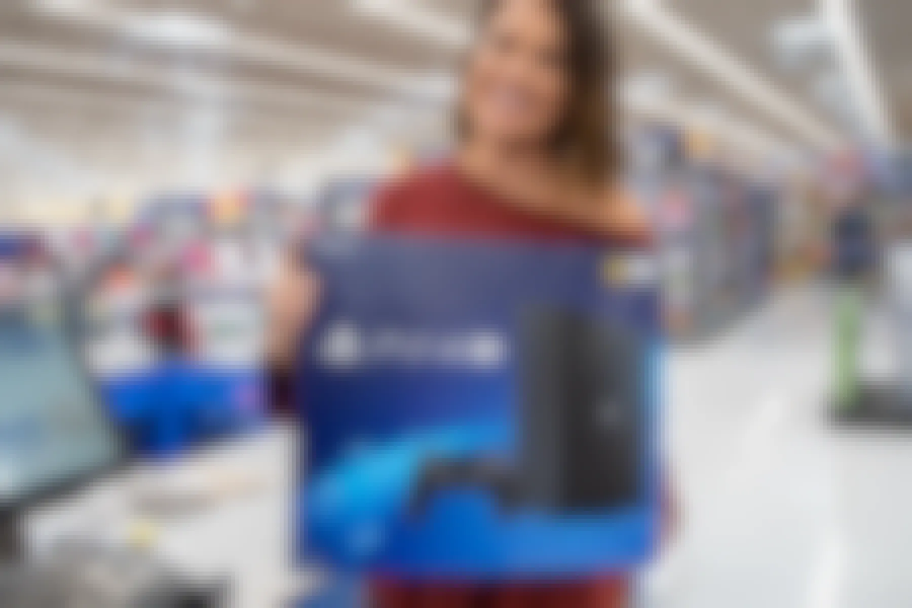 A woman holding a playstation 4 inside Walmart