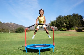 stock photo of little tikes bouncer trampoline with girl in park
