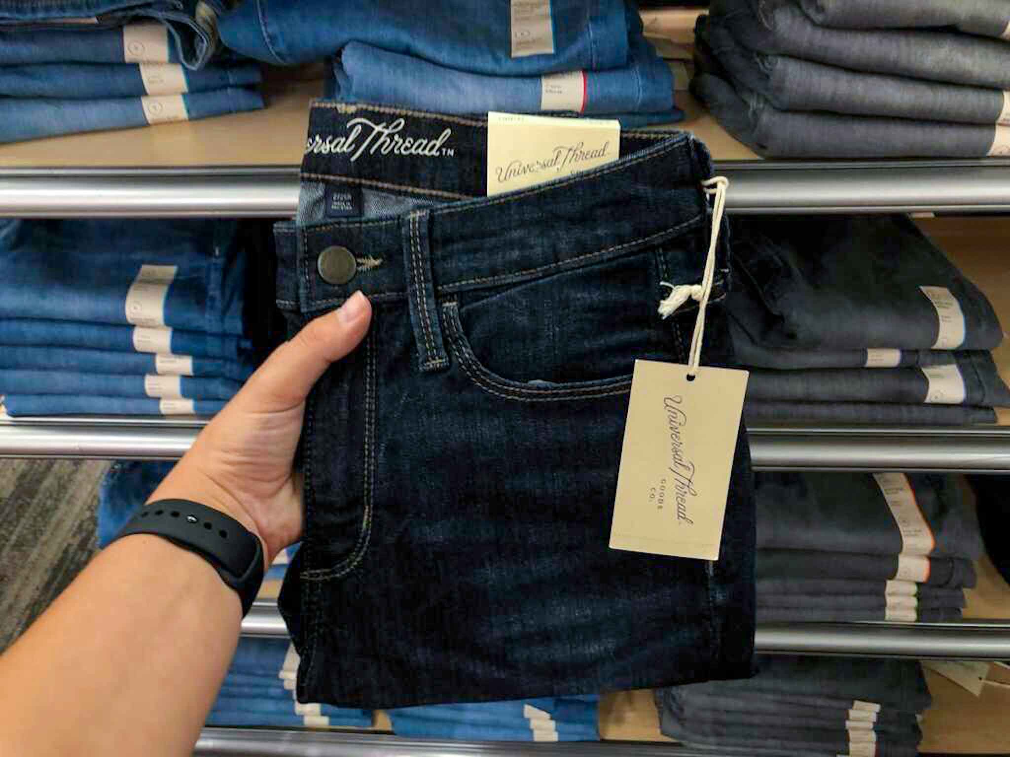 hand holding a universal thread women's jeans at target