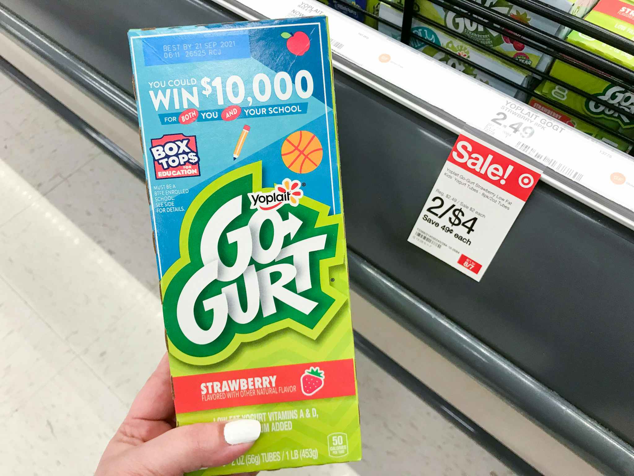 hand holding yoplait go-gurt yogurt tubes at target