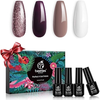 A set of four Beetles nail polish bottles and a gift box.