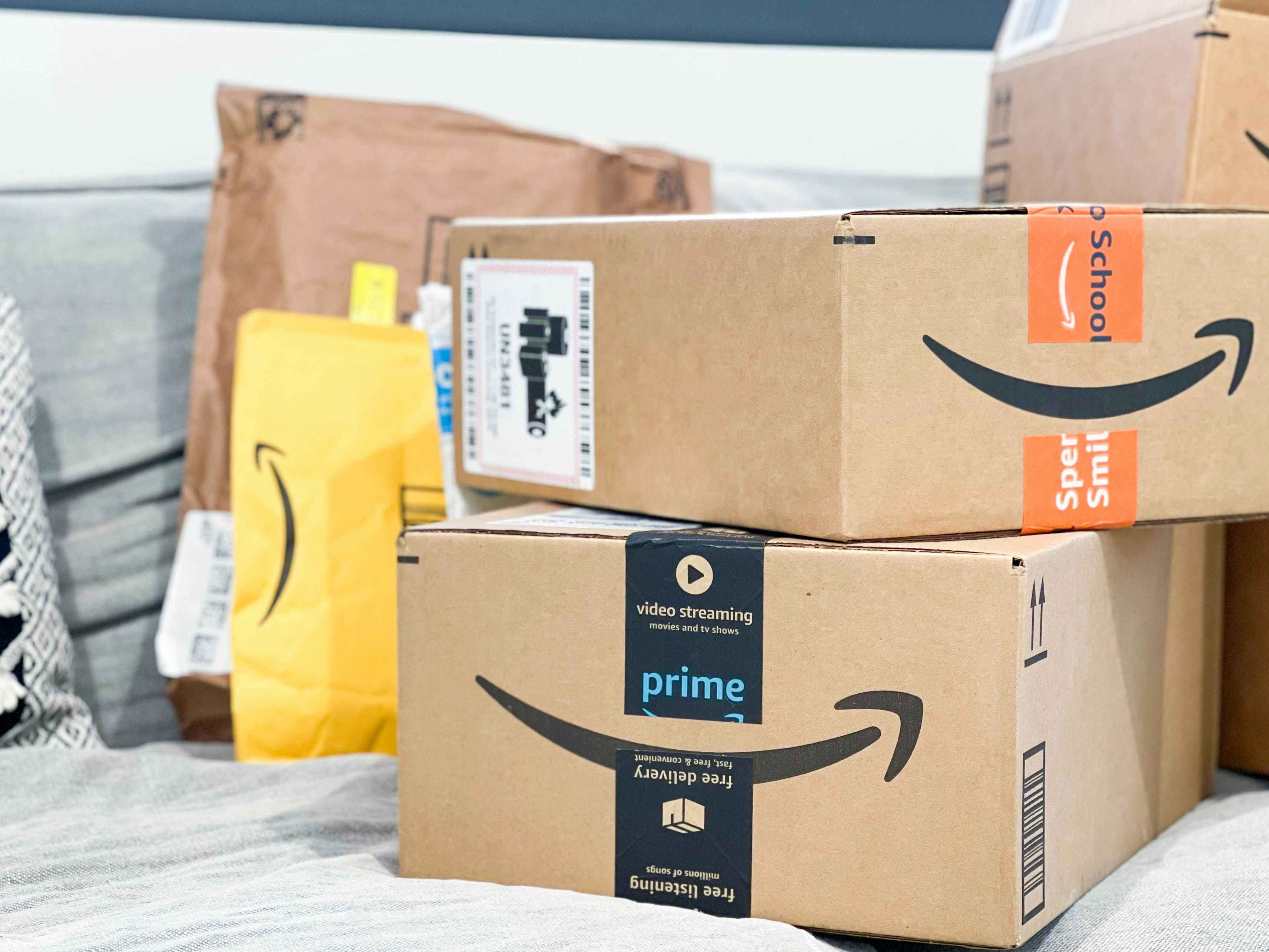 amazon packages and boxes on couch